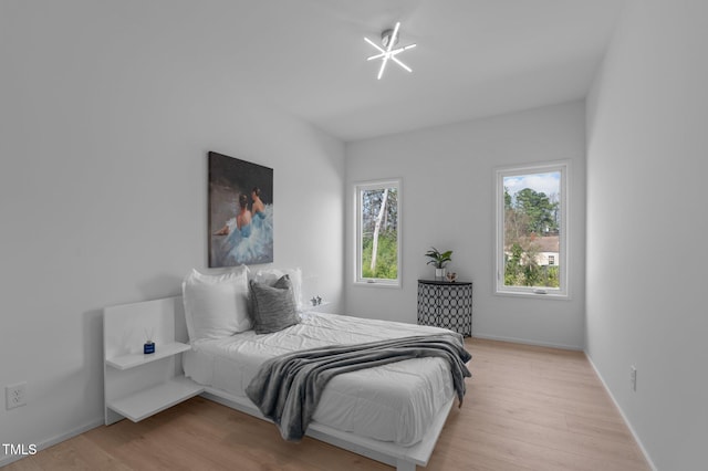 bedroom featuring light wood-style flooring and baseboards