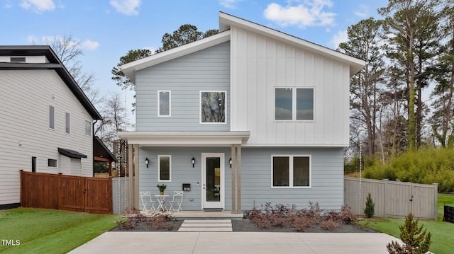 view of front facade with a gate, fence, and board and batten siding