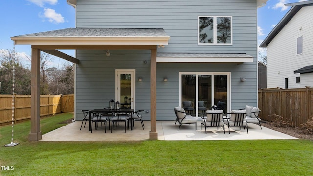 rear view of house with a fenced backyard, a patio, and a yard