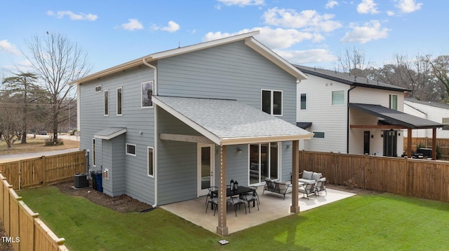 back of property featuring a patio, central AC unit, a fenced backyard, a yard, and roof with shingles