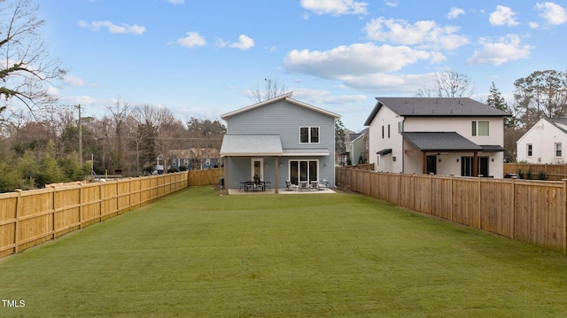 back of house with a patio area, a fenced backyard, and a yard