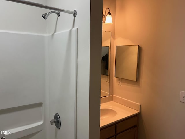 full bathroom featuring a shower and vanity