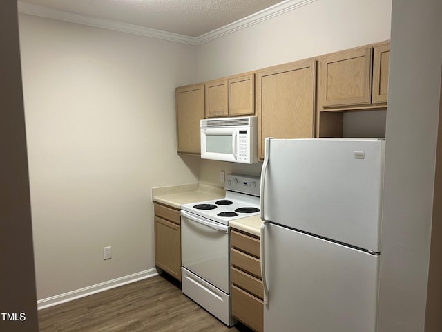 kitchen featuring light brown cabinets, white appliances, wood finished floors, baseboards, and crown molding