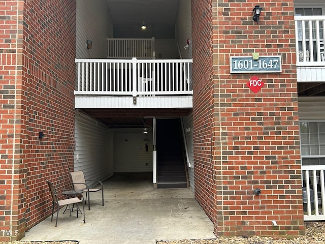 doorway to property with brick siding