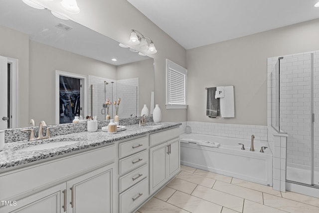 full bathroom featuring double vanity, a stall shower, a sink, and visible vents