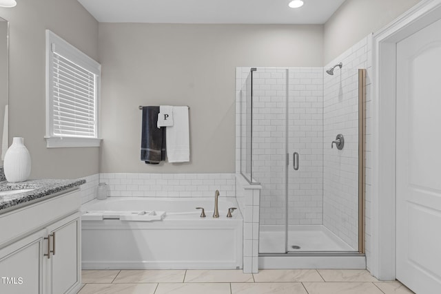 full bathroom with a stall shower, a garden tub, and vanity