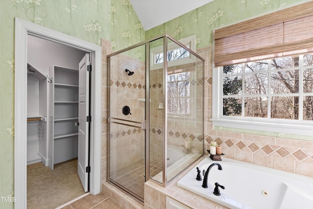 full bath featuring a spacious closet, a shower stall, a tub with jets, and wallpapered walls