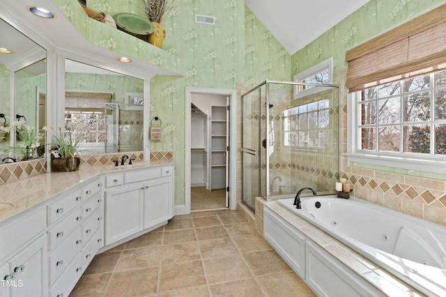 full bathroom featuring a stall shower, plenty of natural light, visible vents, and wallpapered walls