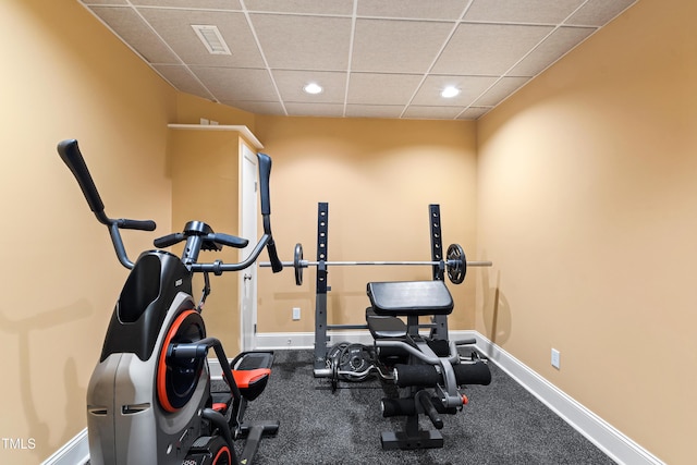 exercise room featuring a paneled ceiling, visible vents, baseboards, and recessed lighting