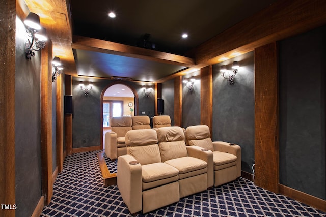 carpeted home theater room featuring baseboards, arched walkways, and recessed lighting