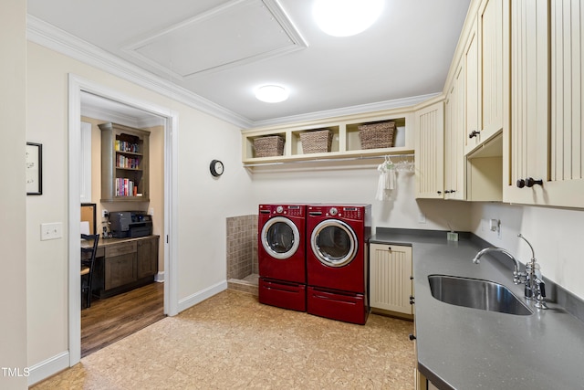 clothes washing area featuring a sink, cabinet space, ornamental molding, and washer and dryer