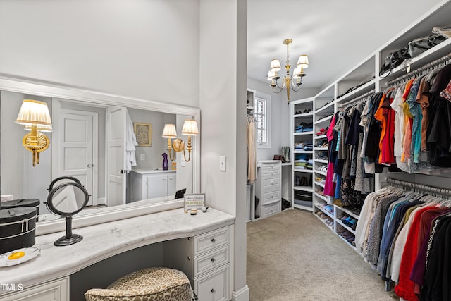 spacious closet featuring a chandelier and carpet flooring