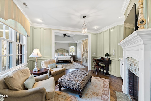 bedroom featuring ornamental molding, a fireplace, and a decorative wall