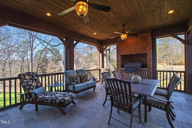 view of patio / terrace with a ceiling fan, outdoor dining space, a grill, and an outdoor living space