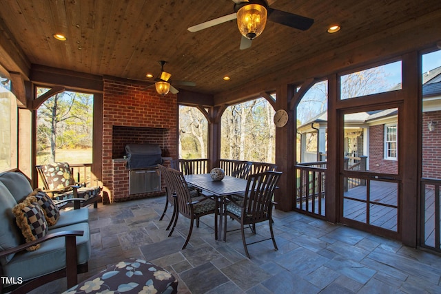 sunroom featuring plenty of natural light and wood ceiling