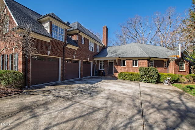 view of front facade with concrete driveway, brick siding, and an attached garage