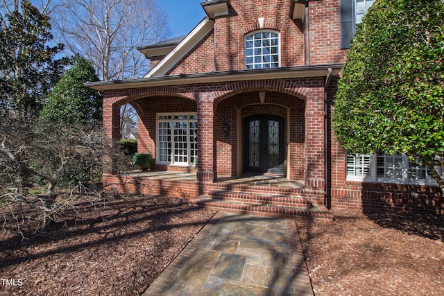 doorway to property with french doors and brick siding