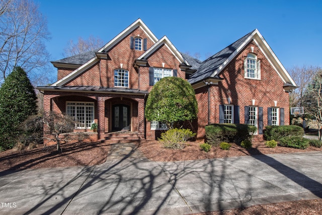 traditional home with french doors and brick siding