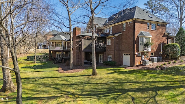 back of house with central AC unit, stairway, a lawn, and brick siding