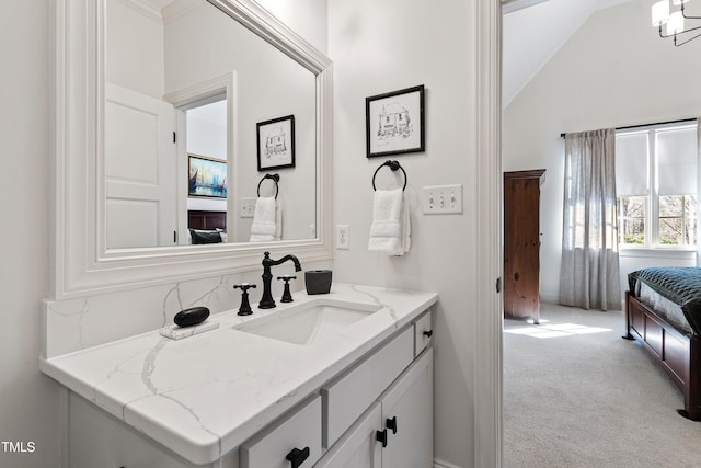 bathroom featuring lofted ceiling and vanity