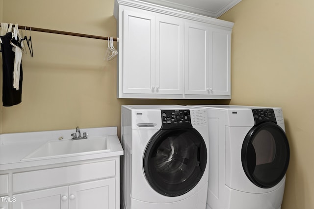 laundry room featuring cabinet space, washer and clothes dryer, and a sink