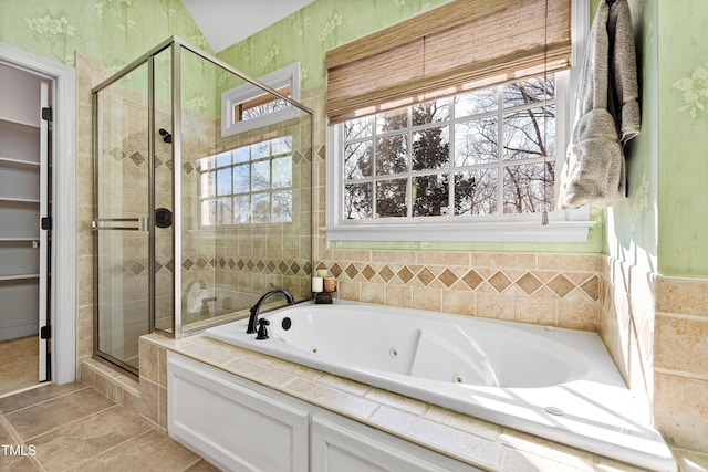 full bath featuring a whirlpool tub, a stall shower, and tile patterned floors