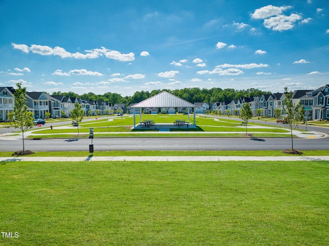 view of property's community with a yard, a gazebo, and a residential view