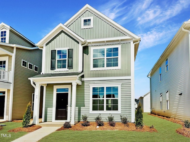 craftsman-style home with board and batten siding and a front lawn