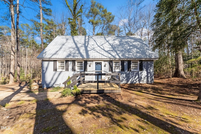 view of front of house with a deck and metal roof