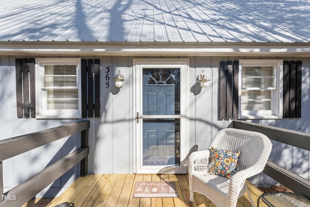 doorway to property featuring metal roof