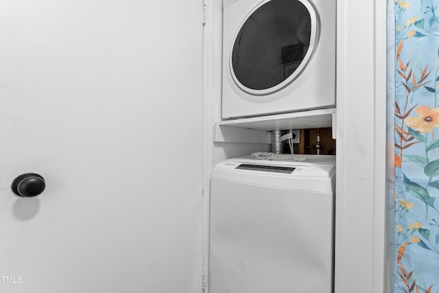 laundry room featuring laundry area and stacked washer / dryer