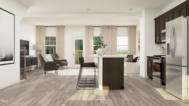 interior space with stainless steel appliances, a breakfast bar, dark brown cabinets, light countertops, and light wood finished floors