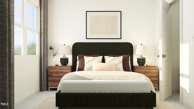 bedroom featuring light carpet, multiple windows, and baseboards