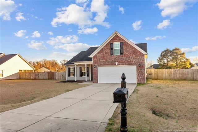 traditional home with a front yard, brick siding, fence, and driveway