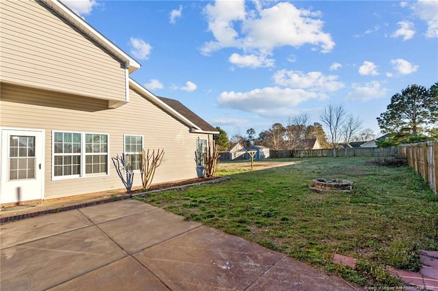 view of yard with an outdoor fire pit, a patio area, and a fenced backyard