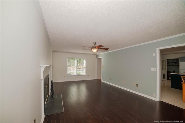 unfurnished living room with a ceiling fan, dark wood-style flooring, a fireplace, and a textured ceiling