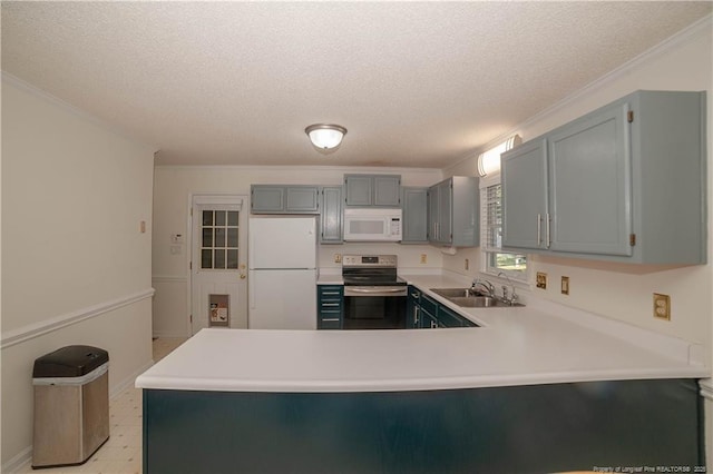 kitchen with a peninsula, white appliances, a sink, light countertops, and crown molding