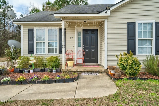 property entrance with a shingled roof