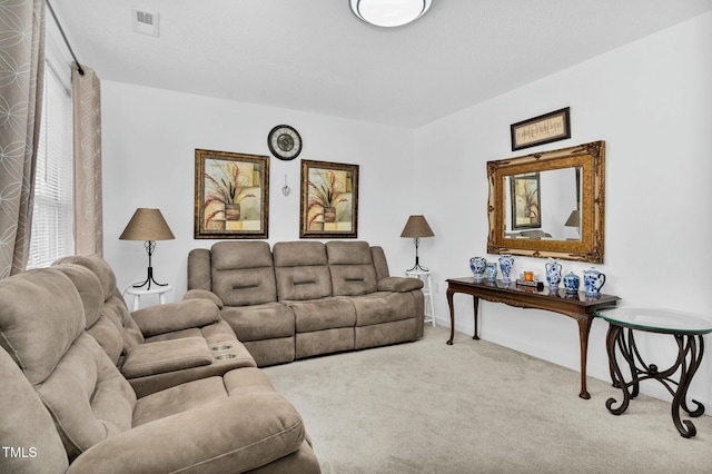 living area with light carpet and visible vents