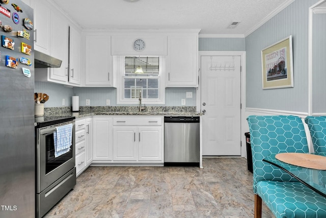 kitchen with stone countertops, white cabinets, appliances with stainless steel finishes, ornamental molding, and extractor fan