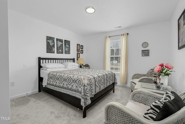 bedroom featuring light carpet, baseboards, and visible vents