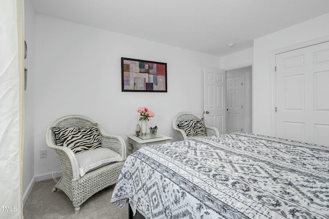 bedroom featuring carpet flooring and baseboards