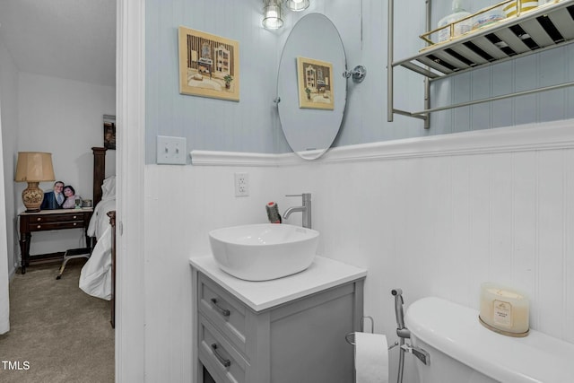 bathroom featuring vanity, ensuite bath, and toilet