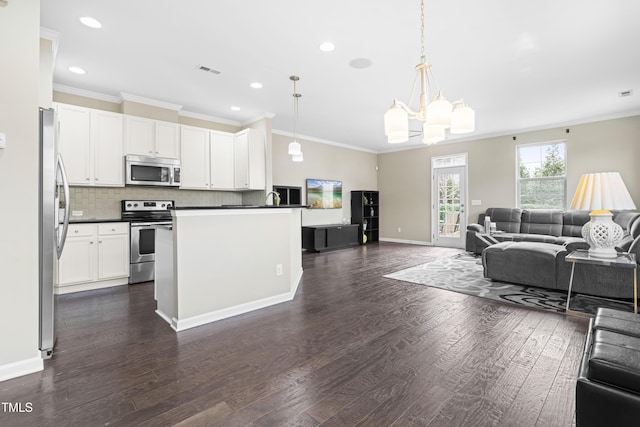 kitchen featuring stainless steel appliances, visible vents, open floor plan, dark countertops, and dark wood finished floors