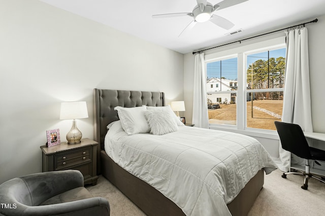 bedroom featuring visible vents, ceiling fan, and light carpet