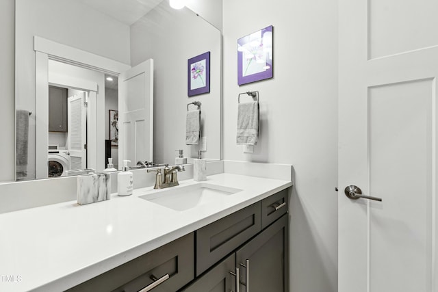 bathroom with washer / clothes dryer and vanity