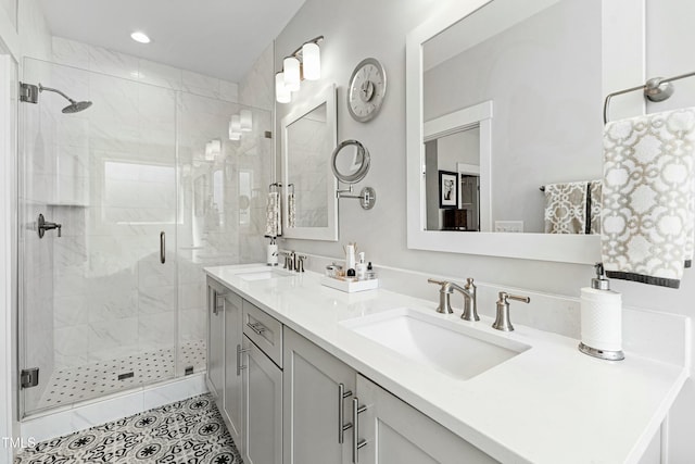 full bath with double vanity, recessed lighting, a sink, and a shower stall