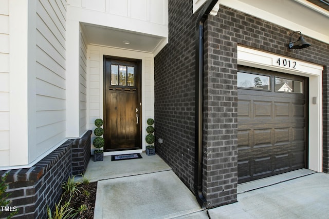 view of exterior entry with brick siding