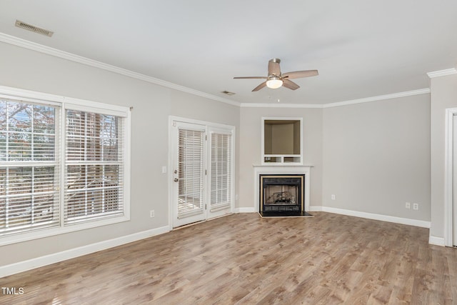 unfurnished living room featuring light wood-style flooring, a fireplace with flush hearth, visible vents, and baseboards