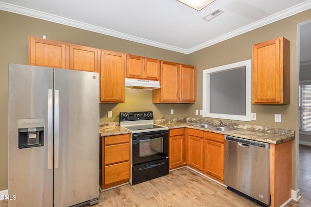 kitchen featuring under cabinet range hood, a sink, light wood-style floors, ornamental molding, and appliances with stainless steel finishes